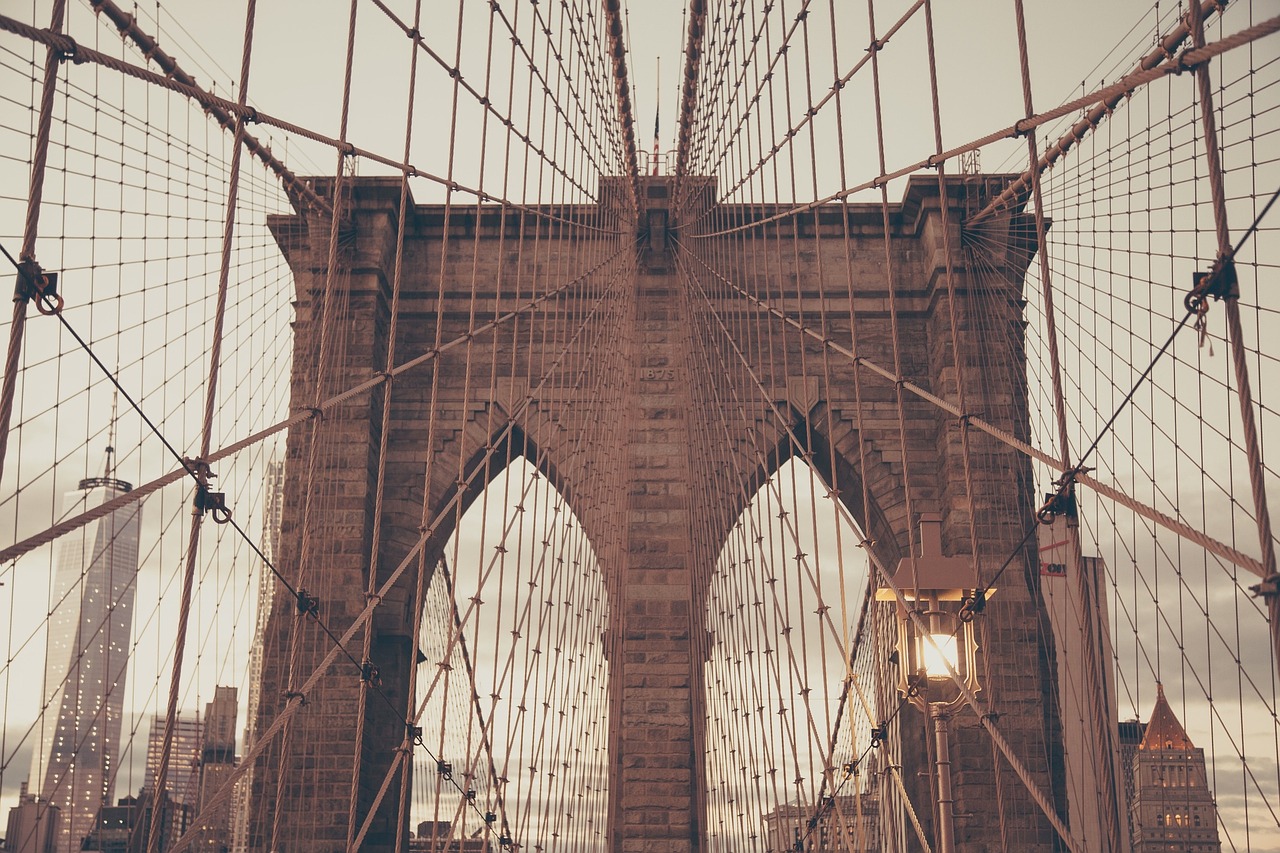 A photo of the Brooklyn Bridge's archways, with suspension cables crisscrossing the visual field.